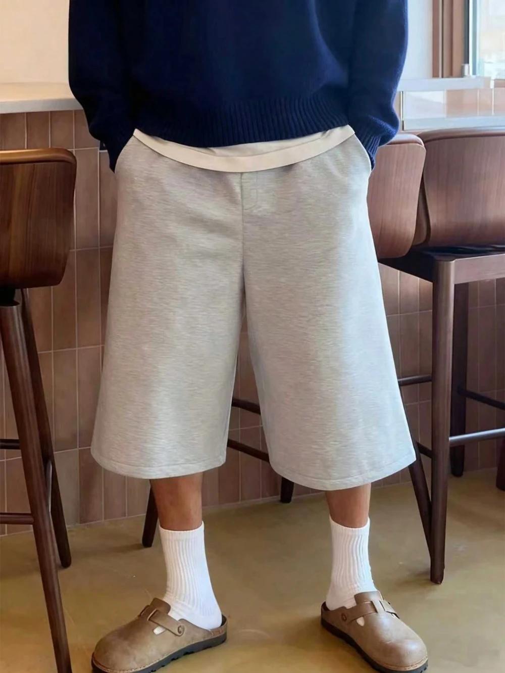 Shorts amples décontractés pour hommes, couleur unie, avec poches obliques, style estival élégant et