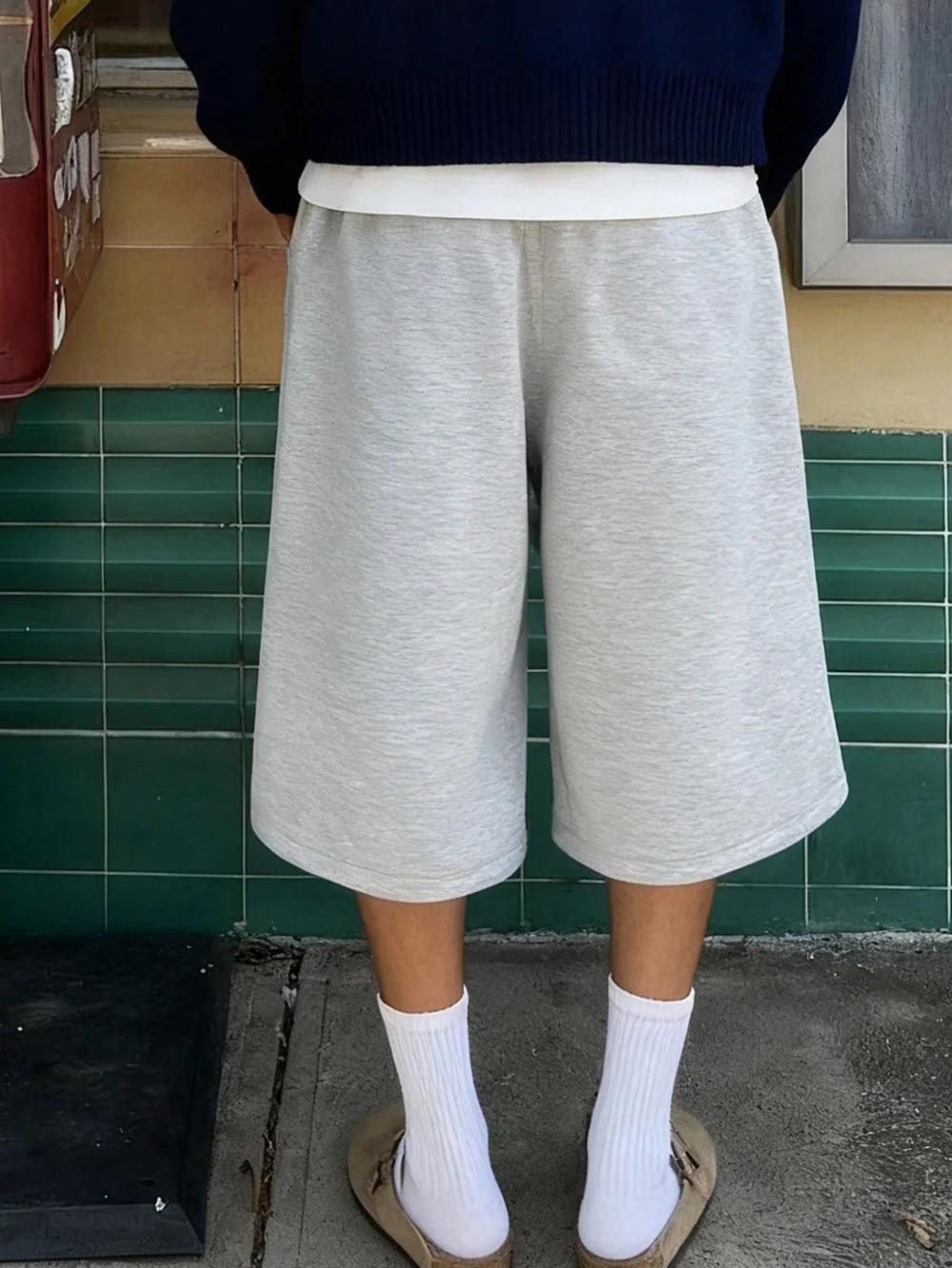 Shorts amples décontractés pour hommes, couleur unie, avec poches obliques, style estival élégant et