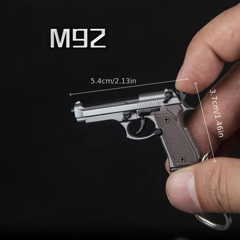 Porte-clés Pistolet Tactique 2025 - Modèle de Pistolet en Alliage 1:4 avec Pompons et Couvercle Tran
