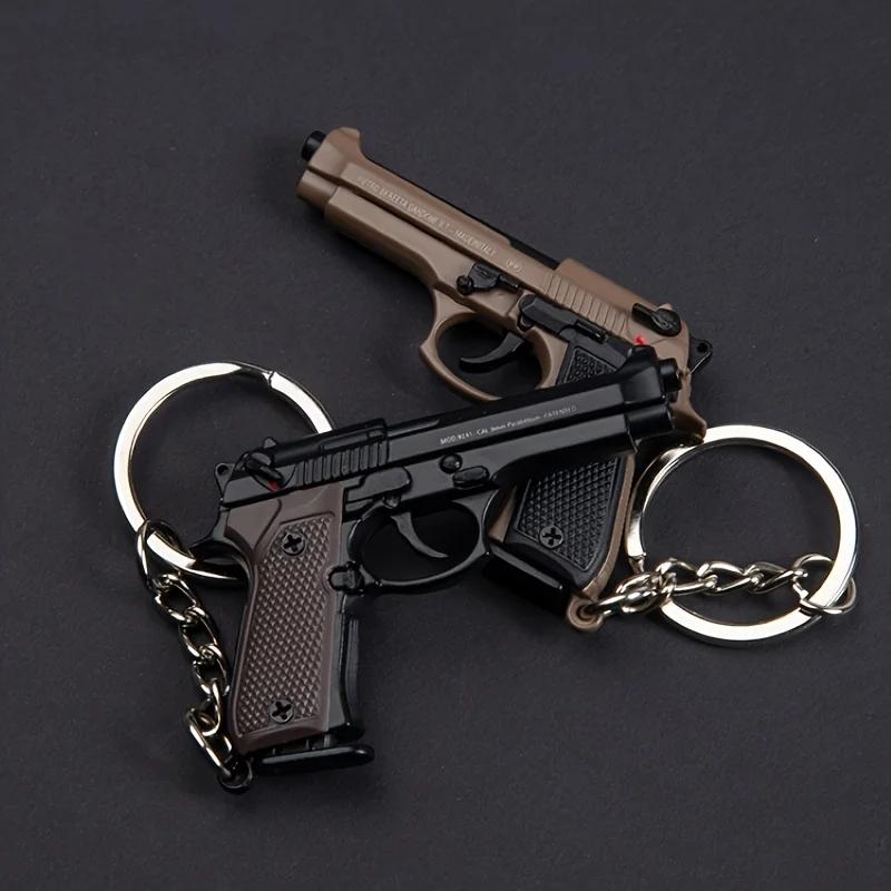 Porte-clés Pistolet Tactique 2025 - Modèle de Pistolet en Alliage 1:4 avec Pompons et Couvercle Tran