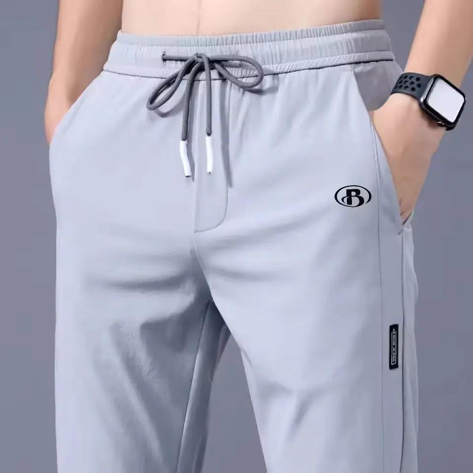 Pantalons pour hommes en soie glacée 2025 été nouveau noir gris mince